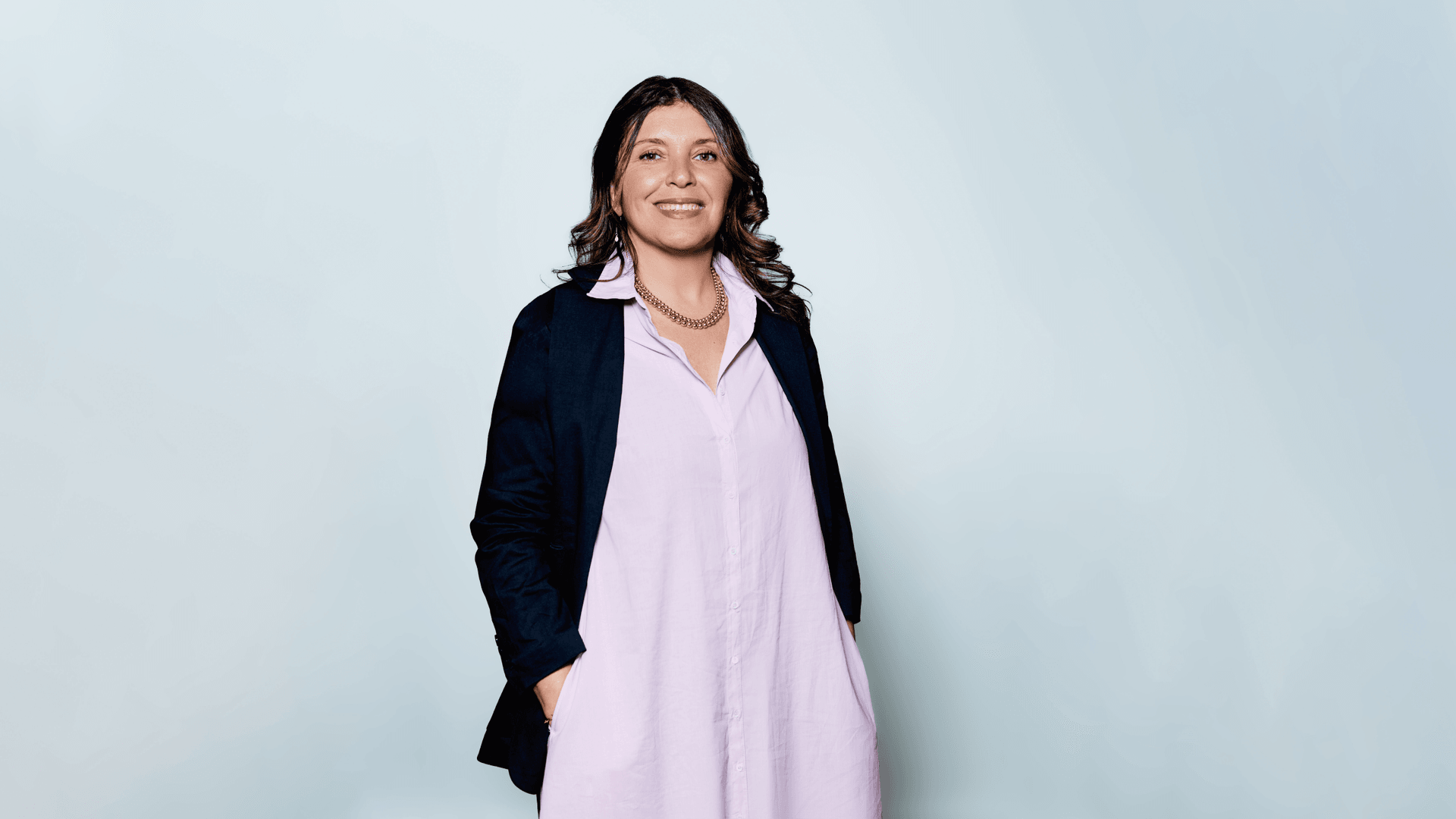 woman in lavender dress and black blazer